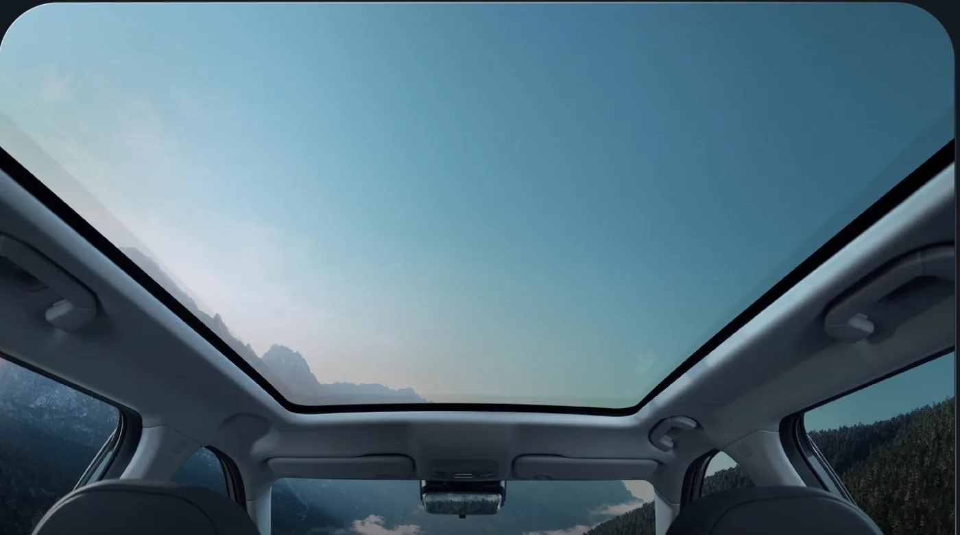 View through the J5 EV panoramic moonroof to open sky.